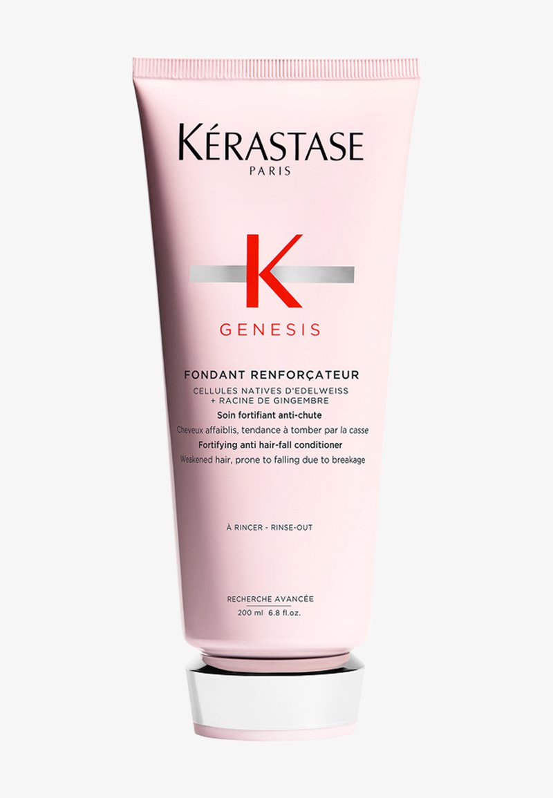 Kérastase Genesis conditioner in een roze tube met een witte basis, met een opvallende rode "K" en zilveren accenten, gelabeld als anti-haaruitval behandeling.
