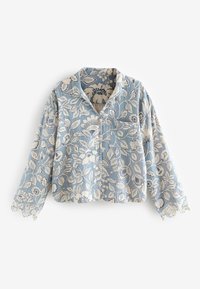 Blue cropped blouse with white floral and leaf pattern, long sleeves, front buttons, and scalloped lace cuffs.