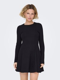 Robe noire à manches longues avec un corsage ajusté et une jupe évasée, confectionnée dans un tissu lisse et extensible. Elle présente un col rond et des coutures minimalistes.