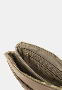Borsa a mano in pelle beige con zip dorata, due scomparti principali e una tasca interna zip con patch logo. Interno in morbido suede.