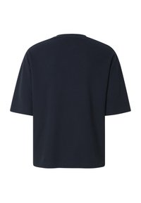 T-shirt noir texturé à manches courtes et col rond, vu de dos, avec une coupe ample et un ourlet droit.