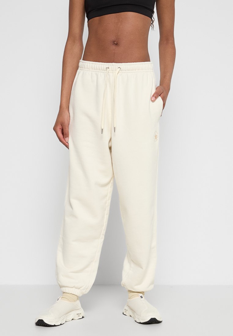 Relaxed-fit crèmekleurige joggers gemaakt van zacht katoen, met een elastische tailleband met strikkoord, zijzakken en geribde boorden.