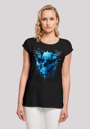 Black t-shirt featuring a blue graphic design of a skull with butterflies, displaying detailed textures and dripping color effects.