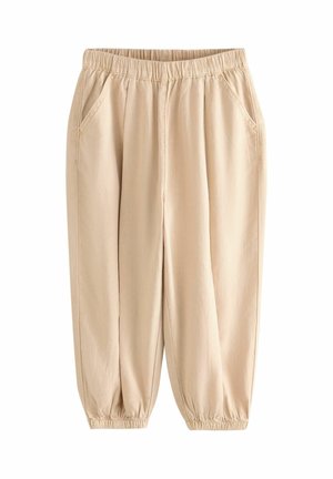 Beżowe casualowe spodnie z elastycznym pasem i mankietami, kieszeniami po bokach z przodu, luźnym krojem, wykonane z lekkiego materiału.