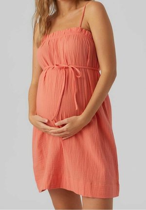 Koralle Maternity-Kleid mit strukturierter Oberfläche, verstellbaren Spaghetti-Trägern, elastischem Oberteil und Bindegürtel unter der Brust.