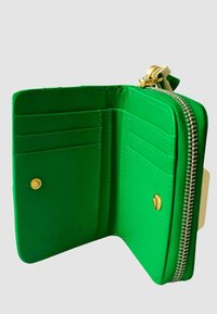 Portafoglio in pelle verde con chiusura a zip. L'interno presenta scomparti per carte e un bottone a pressione. Accenti in hardware dorato e texture liscia.