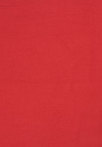 Red linen fabric with a smooth texture, featuring a solid color and subtle, natural wrinkles throughout the surface.
