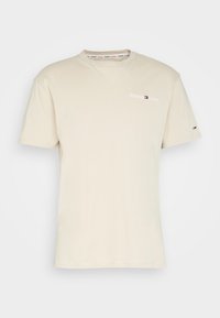 Beige cotton t-shirt with short sleeves, round neckline, and small logo text on the chest. Includes brand detailing on the collar and sleeve.