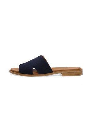 Marineblå slide-sandal med bred ruskindrem, tan-farvet polstret indersål og flad træsål med let hæl på hvid baggrund.