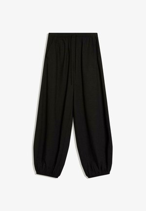 Pantalon ample noir avec taille élastique, cordon de serrage, poches latérales et poignets élastiques froncés, présenté sur fond blanc.