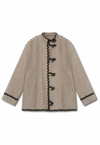 Beige jacket in herringbone pattern, featuring a stand-up collar, black scalloped trim, toggle fastenings, and two side pockets.