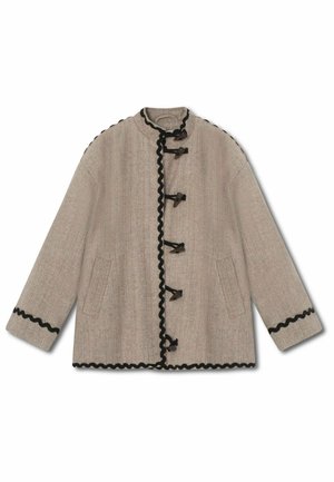 Beige jacket in herringbone pattern, featuring a stand-up collar, black scalloped trim, toggle fastenings, and two side pockets.
