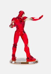 Red crystal figurine of a superhero in a dynamic pose. Features transparent accents, geometric shapes, and a faceted base.