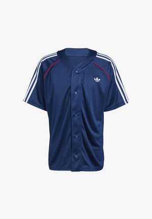 Tumesinine spordisärk nööpidega, valgete kolmerealiste triipudega varrukatel, punase ääristusega õlgade lähedal ning väike valge logo rinnal.