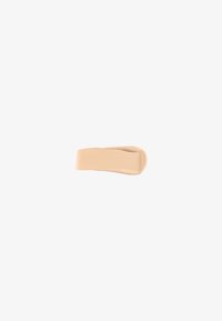 Nude silicone hairband with a smooth texture and a simple, flexible shape designed for holding hair securely without damage.