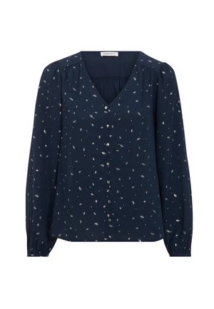 Blouse bleu marine à manches longues avec un petit motif floral blanc, col en V, patte de boutonnage, légers fronçages aux épaules et poignets élastiqués.