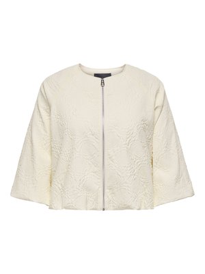 Veste courte couleur crème avec texture florale embossée et fermeture éclair argentée sur le devant, manches larges aux trois-quarts.