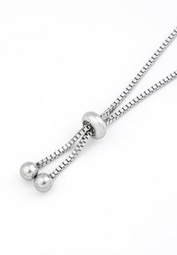 Silver metal necklace featuring a sleek chain design, a circular central component, and two polished spherical ends.