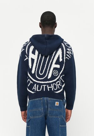 Navy knitted hoodie featuring white graphics saying "HUF" and "AUTHORITY" on the back; ribbed hem and cuffs, with a drawstring hood.