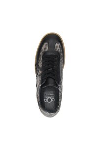 Black sneaker with leopard print panels, black laces, side zipper, and gum sole, viewed from above against a white background.