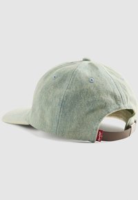 Light blue denim baseball cap with brown adjustable strap and red Levi's tag, shown from back on white background.