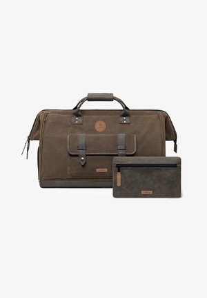 Braune Canvas-Reisetasche mit Ledergriffen, Vorderfach und passender brauner Reißverschlusstasche daneben auf weißem Hintergrund.