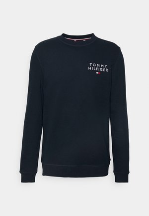 Marineblauwe sweatshirt met ronde hals, lange mouwen en het "Tommy Hilfiger" logo met vlag-embleem op de bovenste linkerkant van de borst.