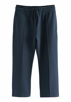 Pantalons de survêtement bleu marine avec une taille élastique, un cordon de serrage et des détails en panneaux latéraux. Fabriqués dans un tissu doux avec une texture lisse et une coupe au niveau de la cheville.