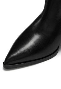 Schwarzer Lederstiefelette mit spitzer Zehenform, glatter Textur und schlankem, schwarzem Absatz. Minimalistisches Design mit eleganter Silhouette.