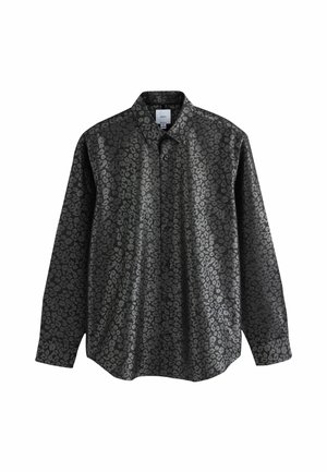 Chemise noire à manches longues avec un motif de léopard subtil et brillant, et un col pointu.