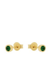 Pendientes de studs en tono dorado con una gema verde circular. Los pendientes tienen un acabado suave y brillante y un diseño simple y redondeado.