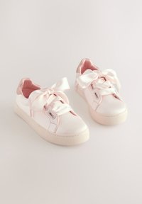 Rosa Satin-Sneaker mit glatter Oberfläche, großen Schleifenbändern, einer strukturierten Gummisohle und einem kontrastierenden pinkfarbenen Fersenakzent.