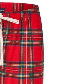 Červené kárované pyžamové šortky s elastickým pasem a bílým stahovacím šňůrkou. Vzor obsahuje zelené, modré a žluté pruhy.