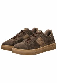Brown suede sneakers with a textured finish, featuring dark brown laces, a contrasting lighter stripe on the side, and a rubber sole.