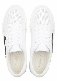 White leather sneakers featuring a textured toe, perforated detailing, flat laces, and a black logo accent on the side.