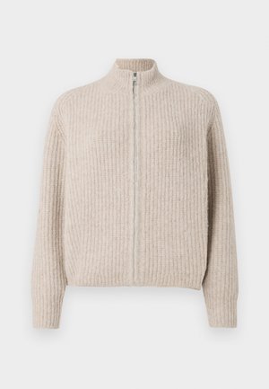 Beige zip-up sweater met een ribbeltextuur, hoge kraag en lange mouwen. Voorzien van een zilveren rits, wat een minimalistische esthetiek geeft.