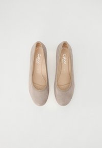 Beige ballet flats with a smooth texture, subtle striped pattern on the upper, and cushioned insoles. Brand logo visible inside.
