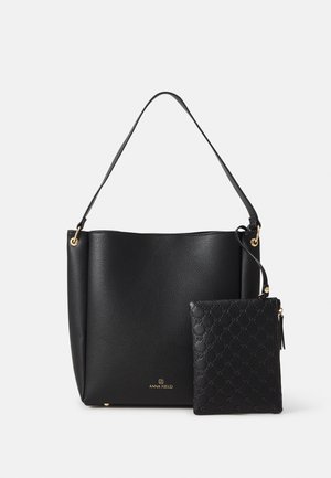 Black leather tote bag with a textured finish, featuring a short handle and a detachable smaller pouch embossed with a pattern. Gold hardware accents.