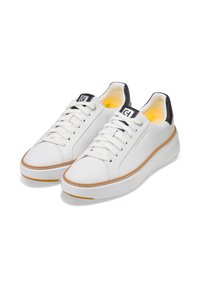 Weiße Leder-Sneaker mit Schnürverschluss, schwarzem Fersenakzent, strukturiierter weißer Sohle und Gummisohle. Mit einer Stichdetail entlang des Randes.