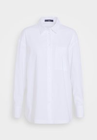 Camicia bianca a maniche lunghe realizzata in misto cotone. Presenta un colletto boton-down e una tasca sul petto. Texture liscia con un design classico.