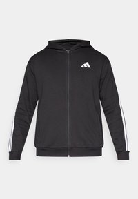 Čierna mikina na zips vyrobená z mäkkej látky. Na hrudi je biely logo a pozdĺž rukávov biele pruhy. Pravidelný strih s kapucňou.