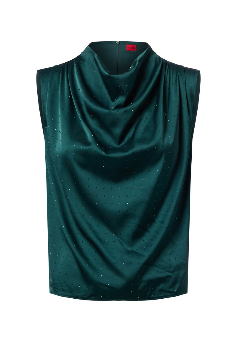Top sans manches en satin vert foncé avec un décolleté drapé, orné de petits embellissements en points argentés pour ajouter de la texture et de l'intérêt. Fermeture éclair au dos.