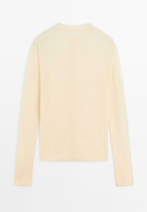 Hellbeige Pullover mit langen Ärmeln und rundem Halsausschnitt, strukturiertem Rippdesign und körpernahem Schnitt. Keine sichtbaren Verzierungen oder Muster.