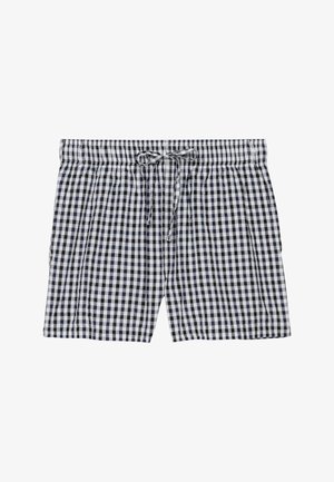 Shorts à carreaux noirs et blancs avec une taille élastique et un cordon à nouer à l'avant, posés à plat sans personnes visibles.