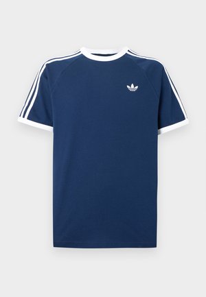 Námornícky modré tričko s bielymi akcentmi, s okrúhlym výstrihom, krátkymi raglánovými rukávmi a malým bielym logom na hrudi. Mäkký bavlnený materiál.