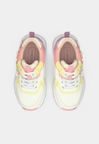 Λευκά αθλητικά παπούτσια με ροζ, κίτρινες και μωβ λεπτομέρειες. Διαθέτουν υφασμάτινο επάνω μέρος, κορδόνια, λουλουδάτη διακόσμηση στο πλάι και μαλακή σόλα.