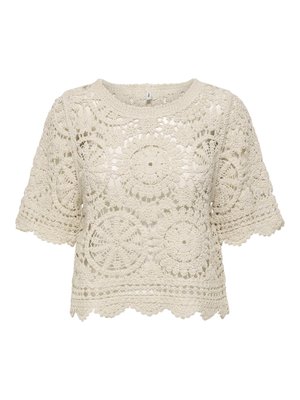 Top en crochet crème à manches courtes avec motifs circulaires et floraux, ourlet et encolure festonnés, texture semi-transparente.