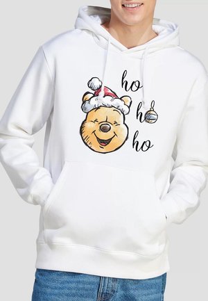 White hoodie featuring a printed illustration of a smiling bear in a red Santa hat, with "ho ho ho" text and a decorative ornament.