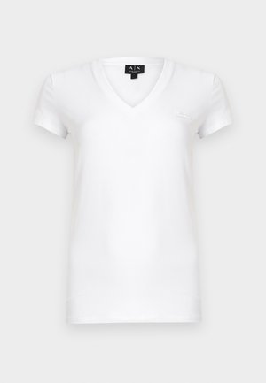 Maglietta bianca a scollo a V in cotone con maniche corte, caratterizzata da un piccolo dettaglio logo sul petto a sinistra. Tessuto dalla texture liscia.