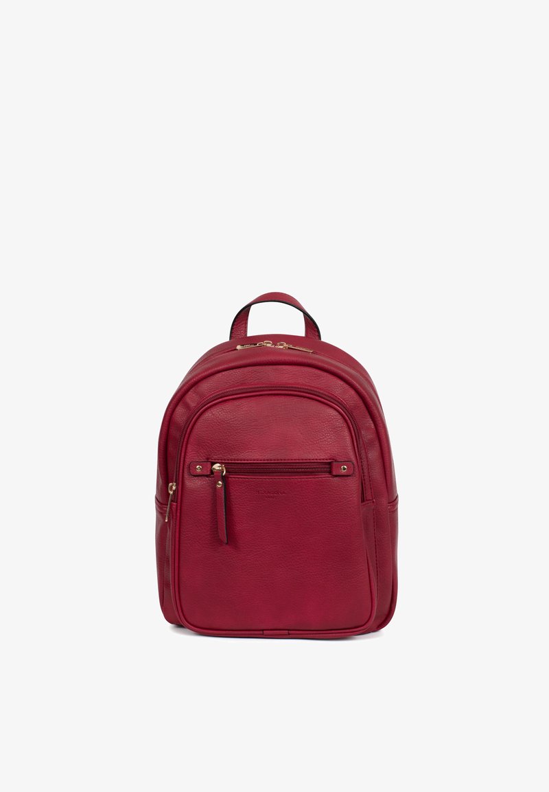 Kleine rode leren rugzak met een voorvak met ritssluiting, bovenste handvat en goudkleurige ritstrekkers tegen een witte achtergrond.